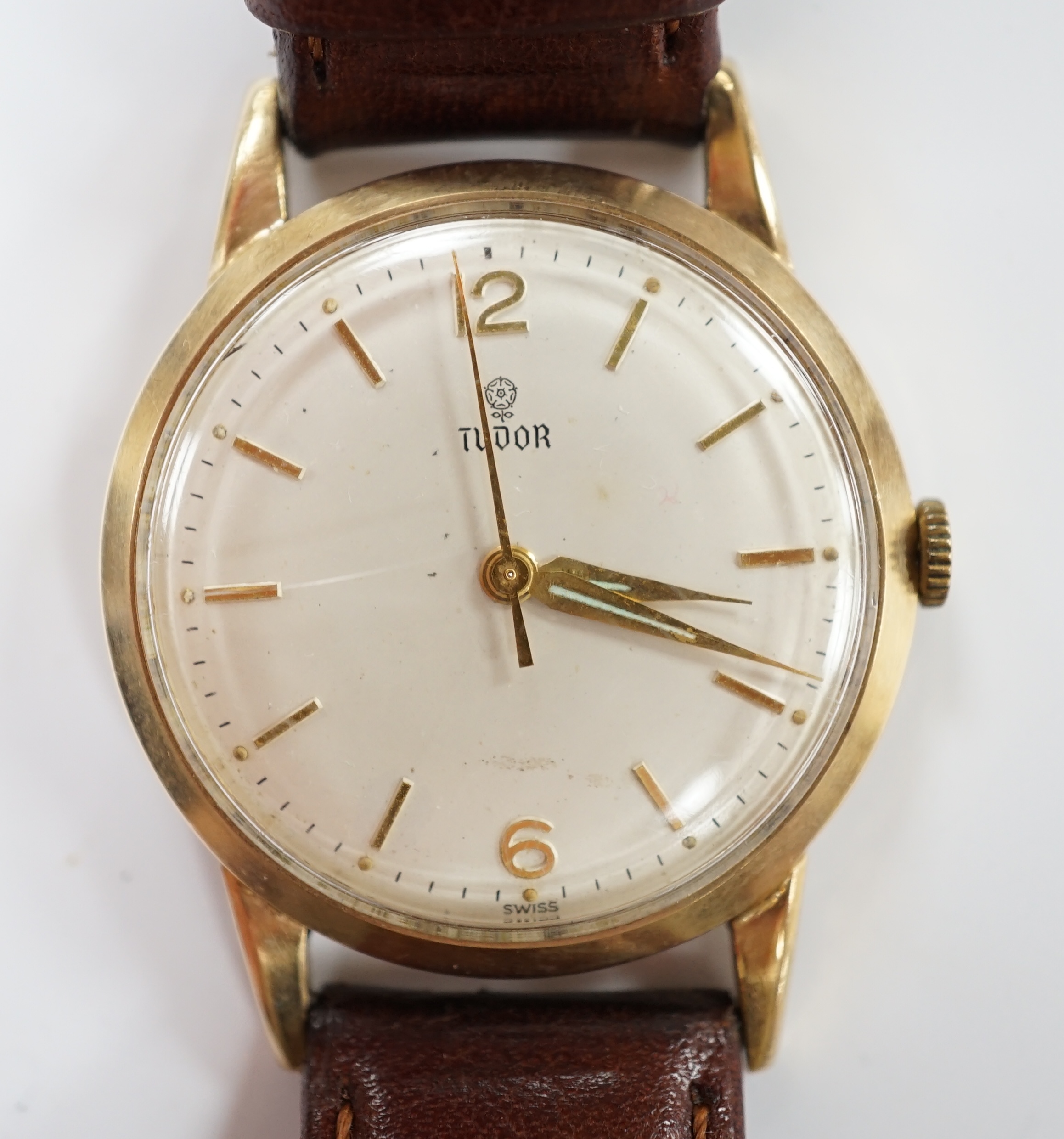 A gentleman's 1960's 9ct gold Tudor manual wind wrist watch, with baton and Arabic numerals later associated leather strap, case diameter 34mm.